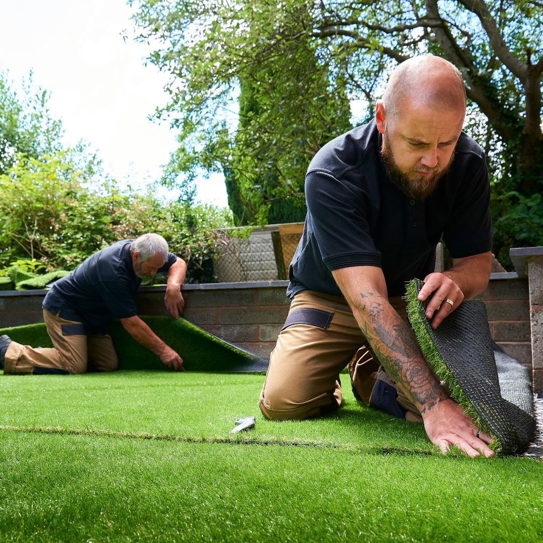 two landscapers installing artificial grass